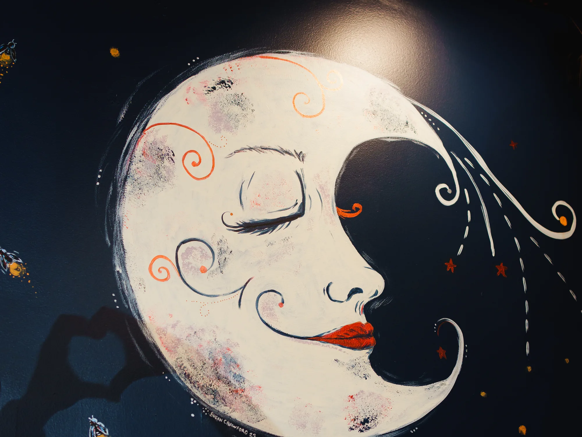 The hand-painted crescent moon mural on the deep navy wall at Corbet Street